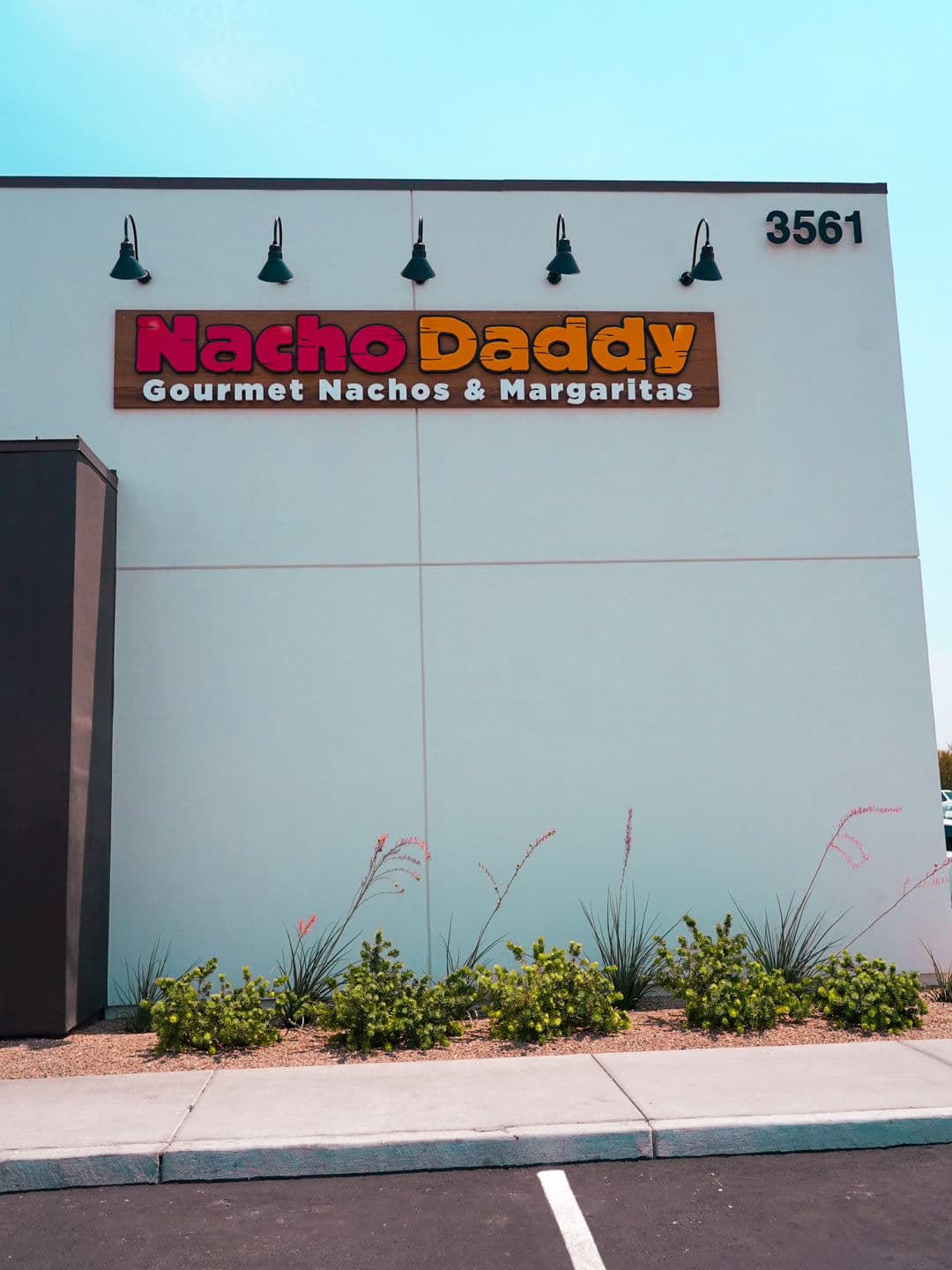Nacho Daddy restaurant sign featuring gourmet nachos and margaritas, located at 3561.